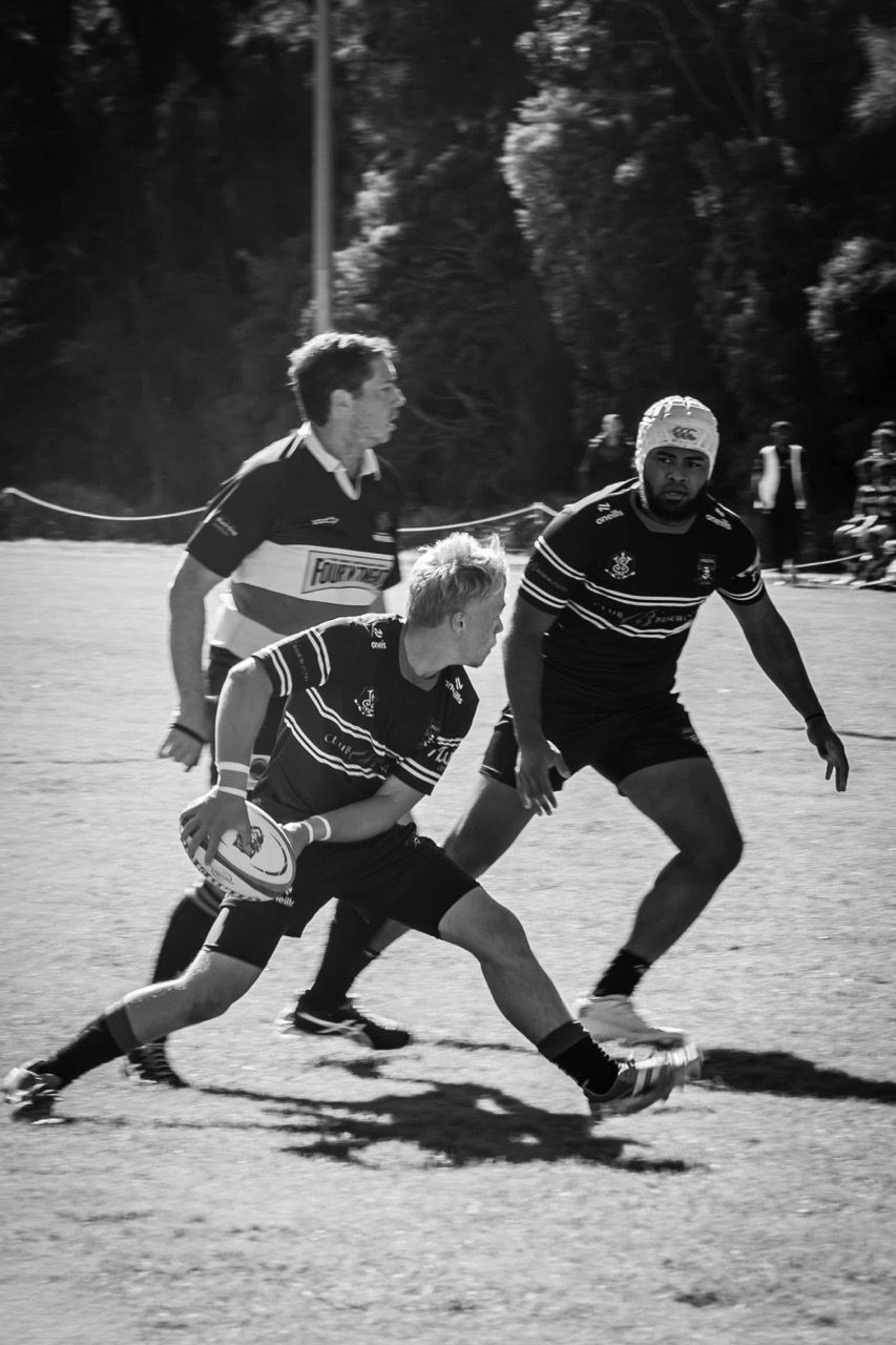 A ball carrier steps past a defender