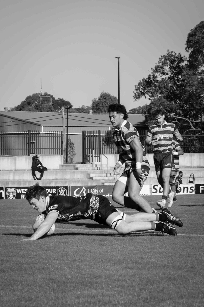 A player dives over the line to score