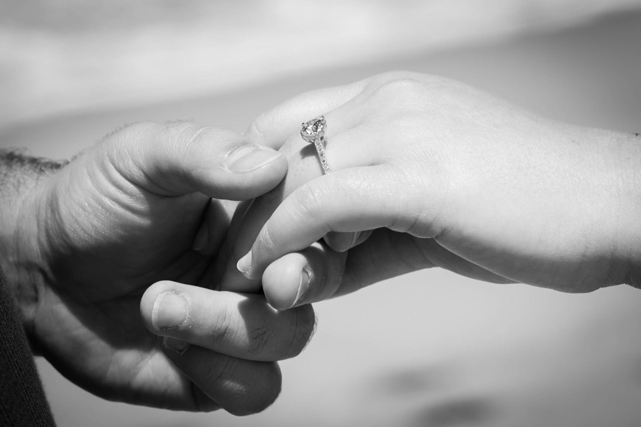 A close-up of the engagement ring in black and white